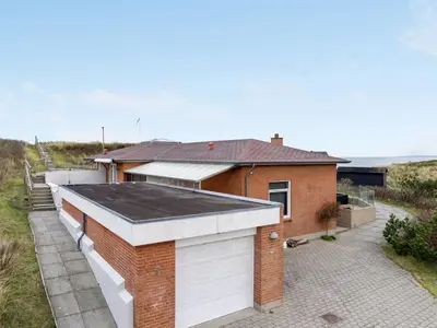 a brick house with a black roof at Holiday Home Fris - 100m from the sea by Interhome in Torsted