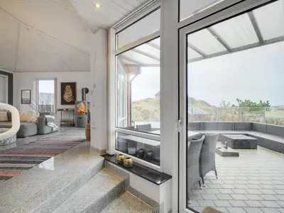 an open living room with a large glass window at Holiday Home Fris - 100m from the sea by Interhome in Torsted