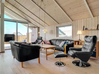 a living room with a couch and chairs and a table at Holiday Home Horsten - 350m from the sea by Interhome in Torsted