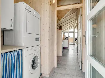 a laundry room with a washer and dryer at Holiday Home Horsten - 350m from the sea by Interhome in Torsted