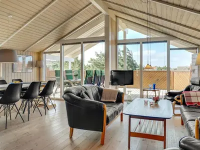a living room with a couch and a table at Holiday Home Horsten - 350m from the sea by Interhome in Torsted