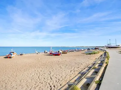 a beach with boats on the sand and the water at Holiday Home Gerlis - 75m from the sea by Interhome in Torsted