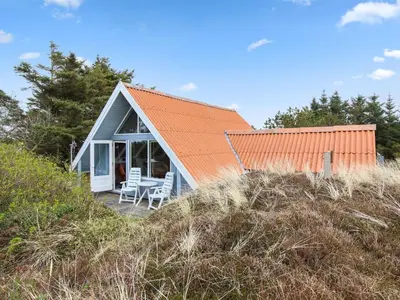 a small house with an orange roof on a beach at Holiday Home Algonda - 500m from the sea by Interhome in Torsted