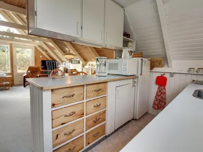 a kitchen with white cabinets and a white refrigerator at Holiday Home Algonda - 500m from the sea by Interhome in Torsted