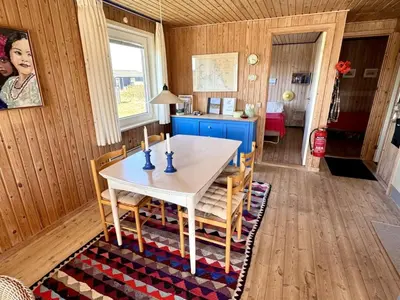 a dining room with a table and chairs at Holiday Home Bera - 250m from the sea by Interhome in Torsted