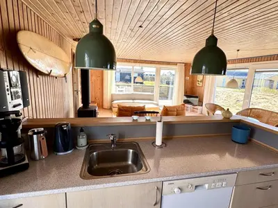 a kitchen with a sink and two pendant lights at Holiday Home Bera - 250m from the sea by Interhome in Torsted
