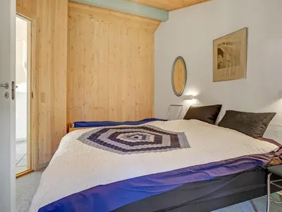 a bedroom with a bed with a quilt on it at Holiday Home Aslak - 350m from the sea by Interhome in Torsted