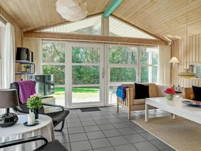 a living room with a large window and a couch at Holiday Home Aslak - 350m from the sea by Interhome in Torsted