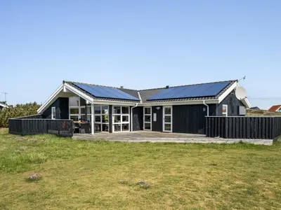 a house with solar panels on the roof at Holiday Home Emppu - 400m from the sea by Interhome in Torsted