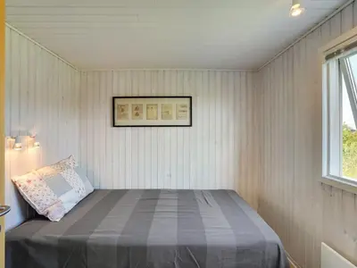 a bed in a small room with a window at Holiday Home Vuokko - 400m from the sea by Interhome in Torsted