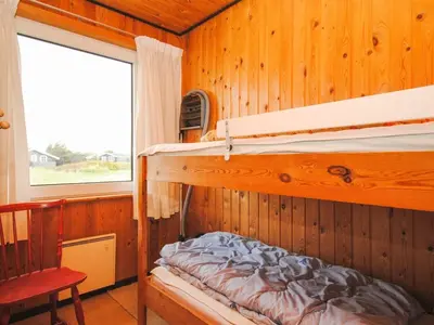 a bedroom with two bunk beds in a cabin at Holiday Home Gisela - 250m from the sea by Interhome in Torsted