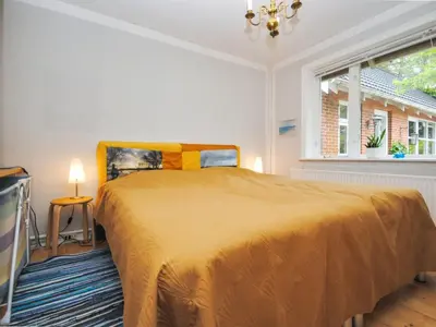 a bedroom with a large bed and a window at Holiday Home Ludovic - 7km from the sea by Interhome in Thisted