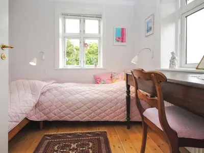a bedroom with a bed and a desk and a chair at Holiday Home Ludovic - 7km from the sea by Interhome in Thisted