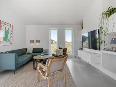 a living room with a couch and a table at Holiday Home Milena - 600m from the sea by Interhome in Torsted