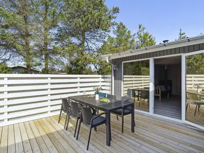 a patio with a table and chairs on a deck at Holiday Home Afke - 900m from the sea by Interhome in Torsted