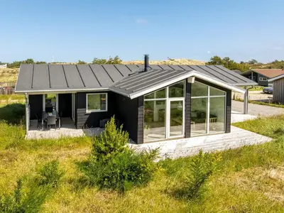 a house with a solar roof on a field at Holiday Home Raakel - 950m from the sea by Interhome in Torsted