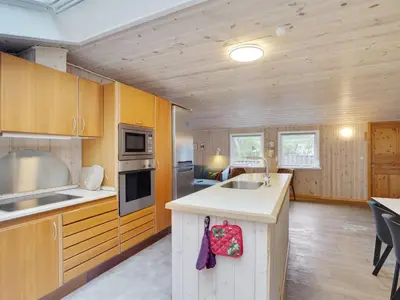 a kitchen with wooden cabinets and a counter top at Holiday Home Anegrete - 900m from the sea by Interhome in Torsted