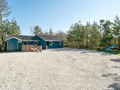 a house with a blue building and a playground at Holiday Home Anegrete - 900m from the sea by Interhome in Torsted