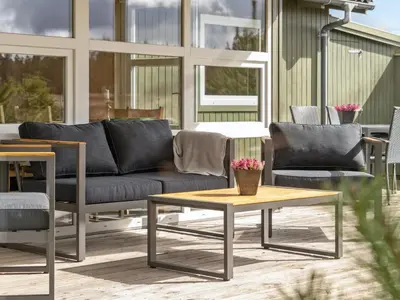 a living room with a couch and a coffee table at Holiday Home Asmir - 1-1km from the sea by Interhome in Torsted