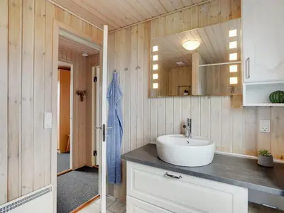 a bathroom with a sink and a mirror at Holiday Home Asmir - 1-1km from the sea by Interhome in Torsted