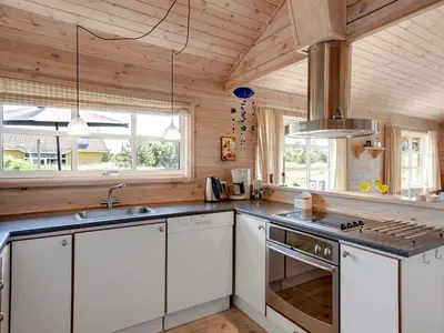 a kitchen with white cabinets and a stove at Holiday Home Eggerich - 900m from the sea by Interhome in Torsted
