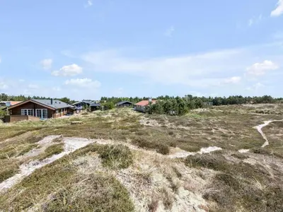 a field of grass with houses in the background at Holiday Home Eggerich - 900m from the sea by Interhome in Torsted