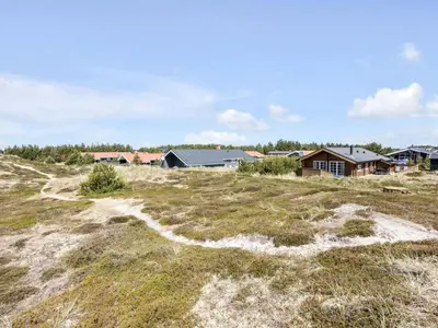 a field of grass with houses in the background at Holiday Home Eggerich - 900m from the sea by Interhome in Torsted