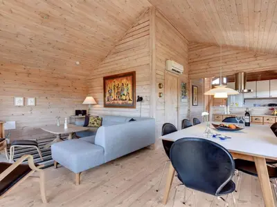 a kitchen and living room with a table and chairs at Holiday Home Eggerich - 900m from the sea by Interhome in Torsted