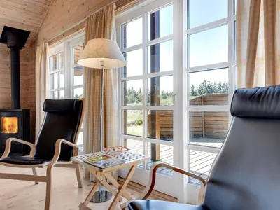 a living room with two chairs and a table and a window at Holiday Home Eggerich - 900m from the sea by Interhome in Torsted