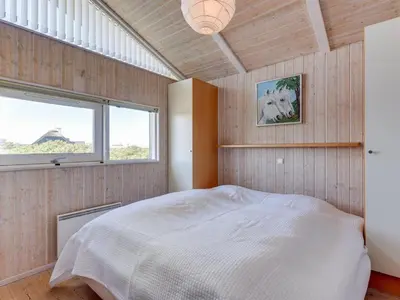 a bedroom with a bed and a window in it at Holiday Home Rink - 150m from the sea by Interhome in Torsted