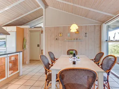 a dining room with a table and chairs at Holiday Home Rink - 150m from the sea by Interhome in Torsted