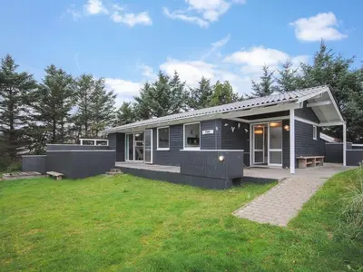 a small blue house with a grass yard at Holiday Home Amber - 500m from the sea by Interhome in Torsted