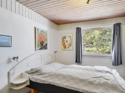 a bedroom with a bed and a window at Holiday Home Germund - 900m from the sea by Interhome in Torsted