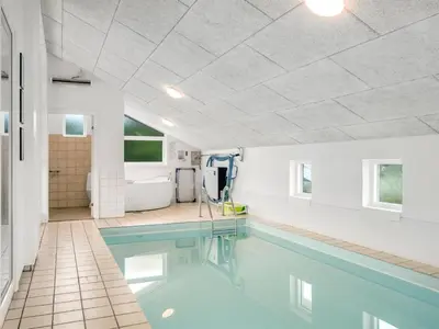 a swimming pool in a house with a white ceiling at Holiday Home Luzy - 600m from the sea by Interhome in Torsted