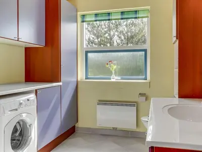 a kitchen with a washing machine and a window at Holiday Home Bodulf - 600m from the sea by Interhome in Torsted