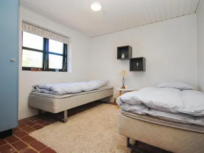 a bedroom with two beds and a window at Holiday Home Duco - 300m from the sea by Interhome in Torsted