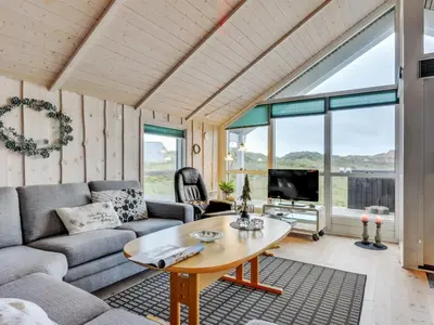 a living room with a couch and a table at Holiday Home Thyrger - 550m from the sea by Interhome in Torsted