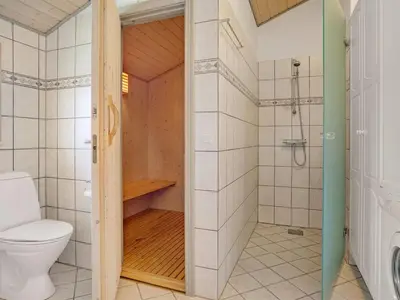 a bathroom with a toilet and a shower at Holiday Home Ivar - 900m from the sea by Interhome in Torsted