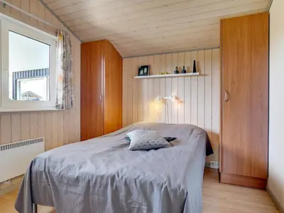 a bedroom with a bed in a room with a window at Holiday Home Ivar - 900m from the sea by Interhome in Torsted