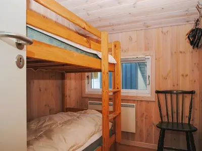 a bedroom with a bunk bed in a cabin at Holiday Home Laurentia - 800m from the sea by Interhome in Torsted