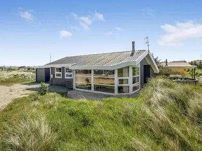 a house on the beach with a grassy field at Holiday Home Laurentius - 300m from the sea by Interhome in Torsted