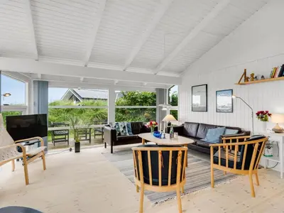 a living room with a couch and a table at Holiday Home Laurentius - 300m from the sea by Interhome in Torsted
