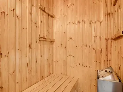 a wooden room with a bench in a wooden wall at Holiday Home Laurentius - 300m from the sea by Interhome in Torsted
