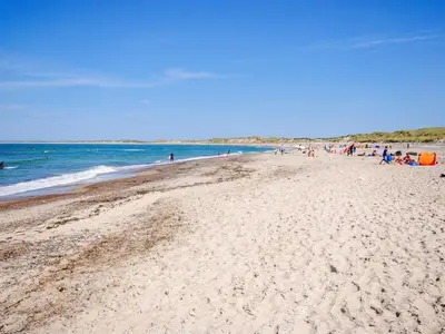 a group of people walking on a beach at Holiday Home Vivina - 250m from the sea by Interhome in Torsted