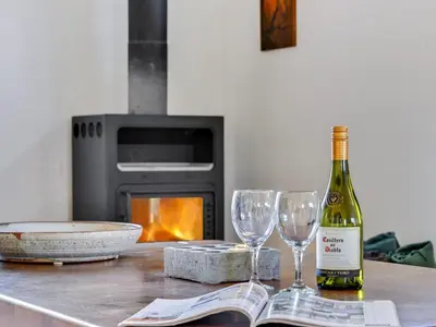 a bottle of wine and two wine glasses on a table at Holiday Home Vivina - 250m from the sea by Interhome in Torsted