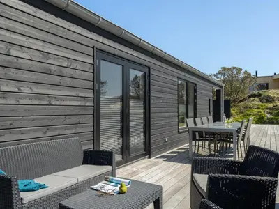 a patio with chairs and a table on a house at Holiday Home Helli - 650m from the sea by Interhome in Torsted