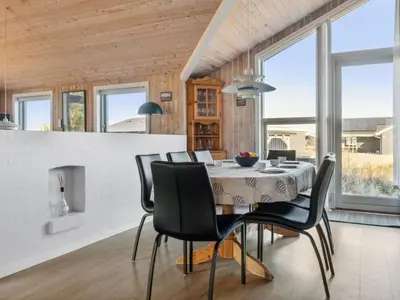 a dining room with a table and chairs at Holiday Home Øde - 350m from the sea by Interhome in Torsted