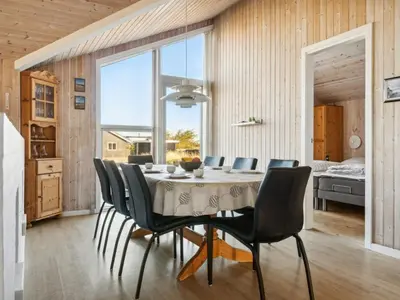 a dining room with a table and chairs at Holiday Home Øde - 350m from the sea by Interhome in Torsted