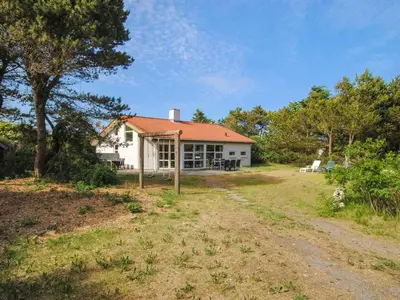 a white house with an orange roof at Holiday Home Konrad - 400m from the sea by Interhome in Torsted