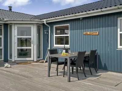 a patio with a table and chairs on a deck at Holiday Home Fabiana - 350m from the sea by Interhome in Torsted
